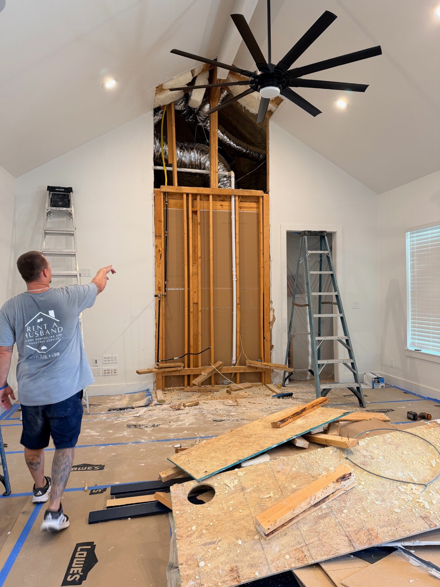 Fireplace wall opened up during renovation, with framing and ductwork visible